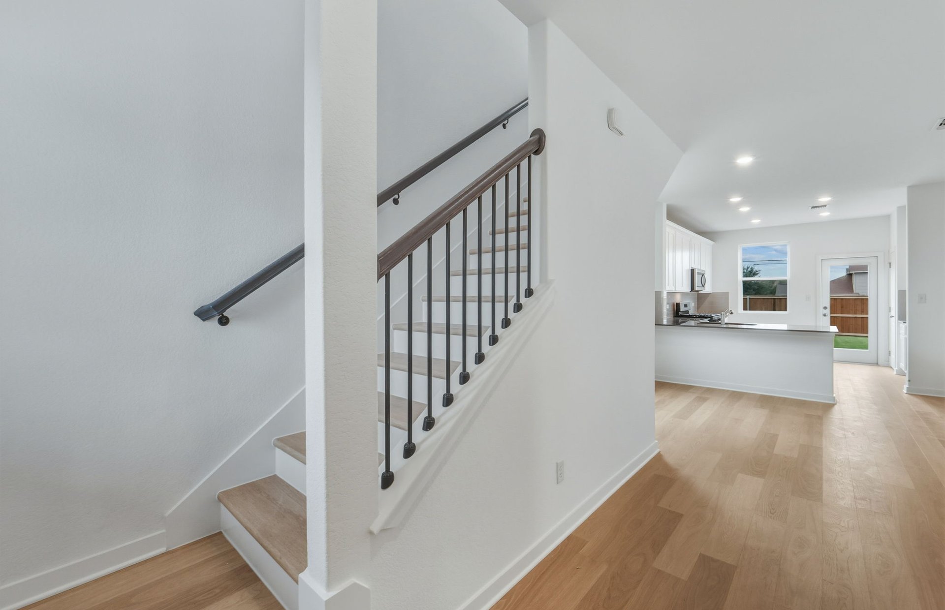 341 Sullivan Way Elgin, TX 78621 - Photo 17 of 23 a view of a hallway with wooden floor and staircase
