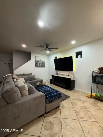 a living room with furniture and a flat screen tv