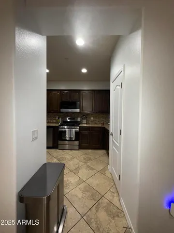 a kitchen with stainless steel appliances a refrigerator and a stove top oven
