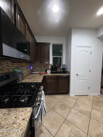 a kitchen with a stove a sink and a microwave