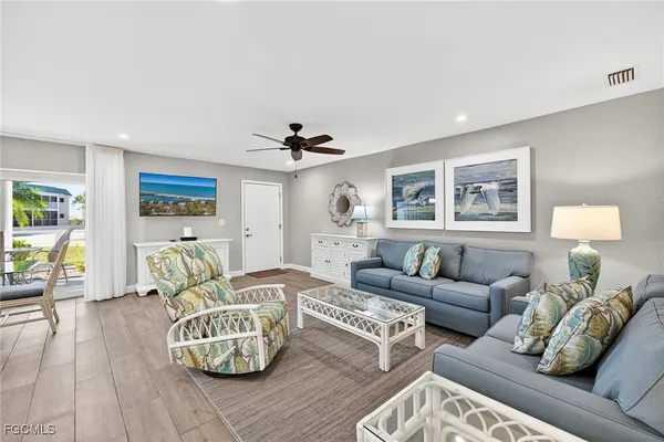 a living room with furniture and wooden floor