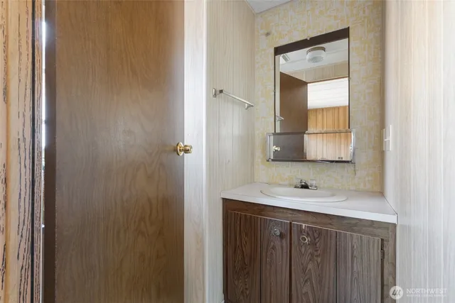 a bathroom with a sink a mirror and a vanity