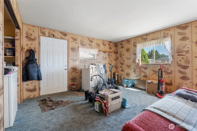 a bedroom with bed and a window