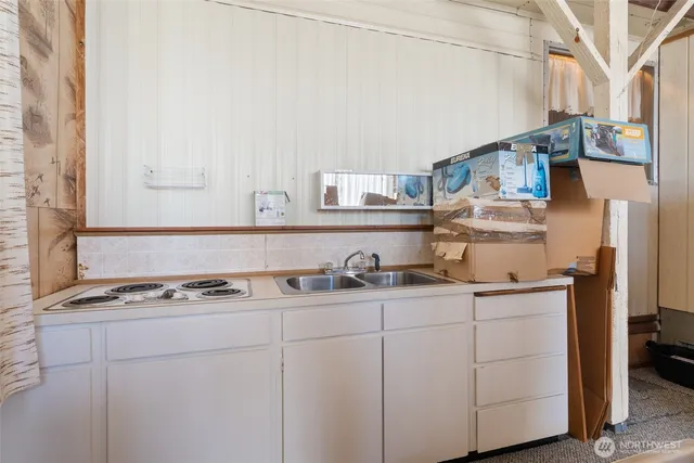 a kitchen with stainless steel appliances granite countertop a sink and cabinets