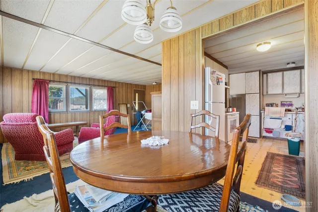 a dining room with furniture and wooden floor