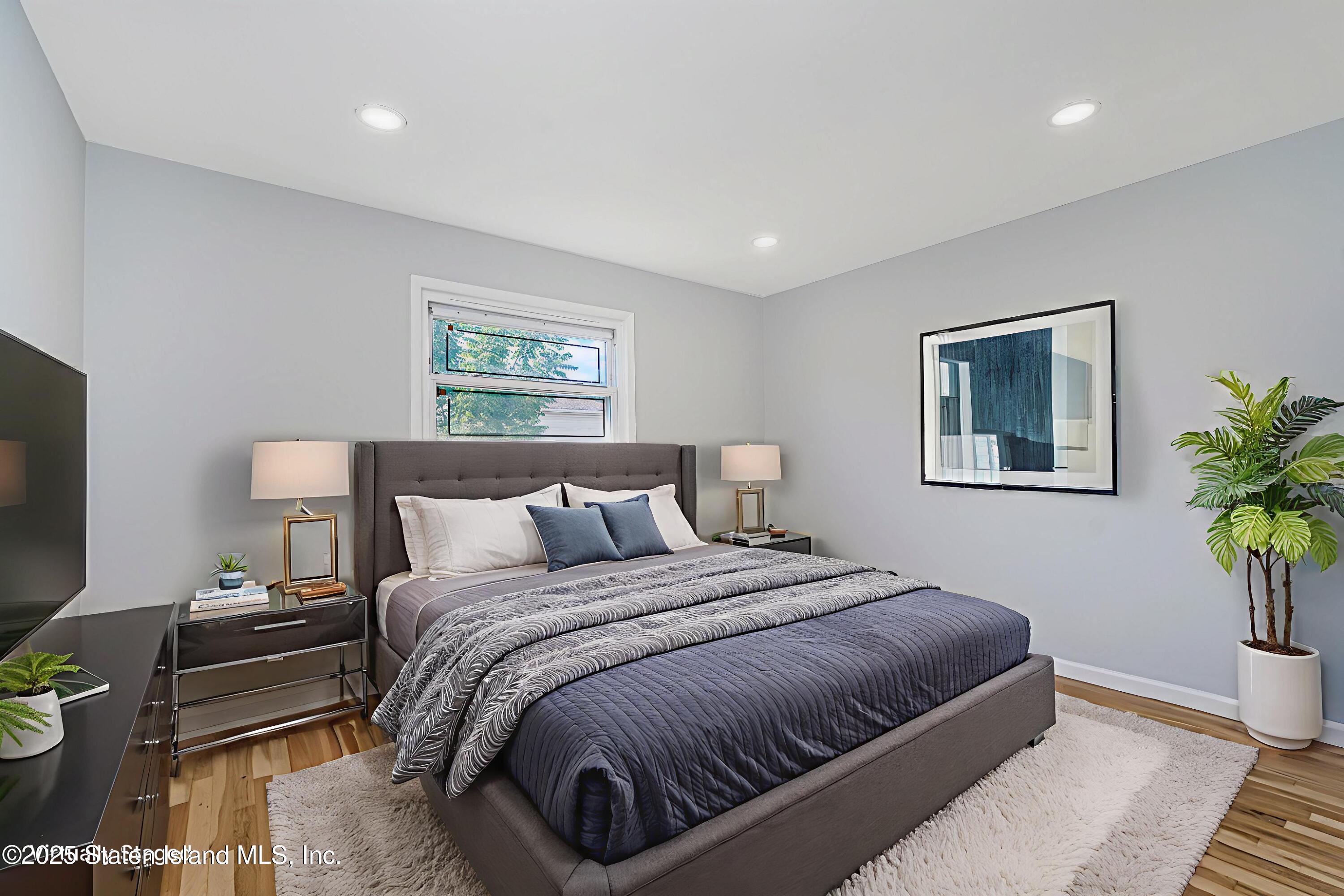 622 Barlow Avenue Staten Island, NY 10312 - Photo 11 of 27 a bedroom with bed and a potted plant