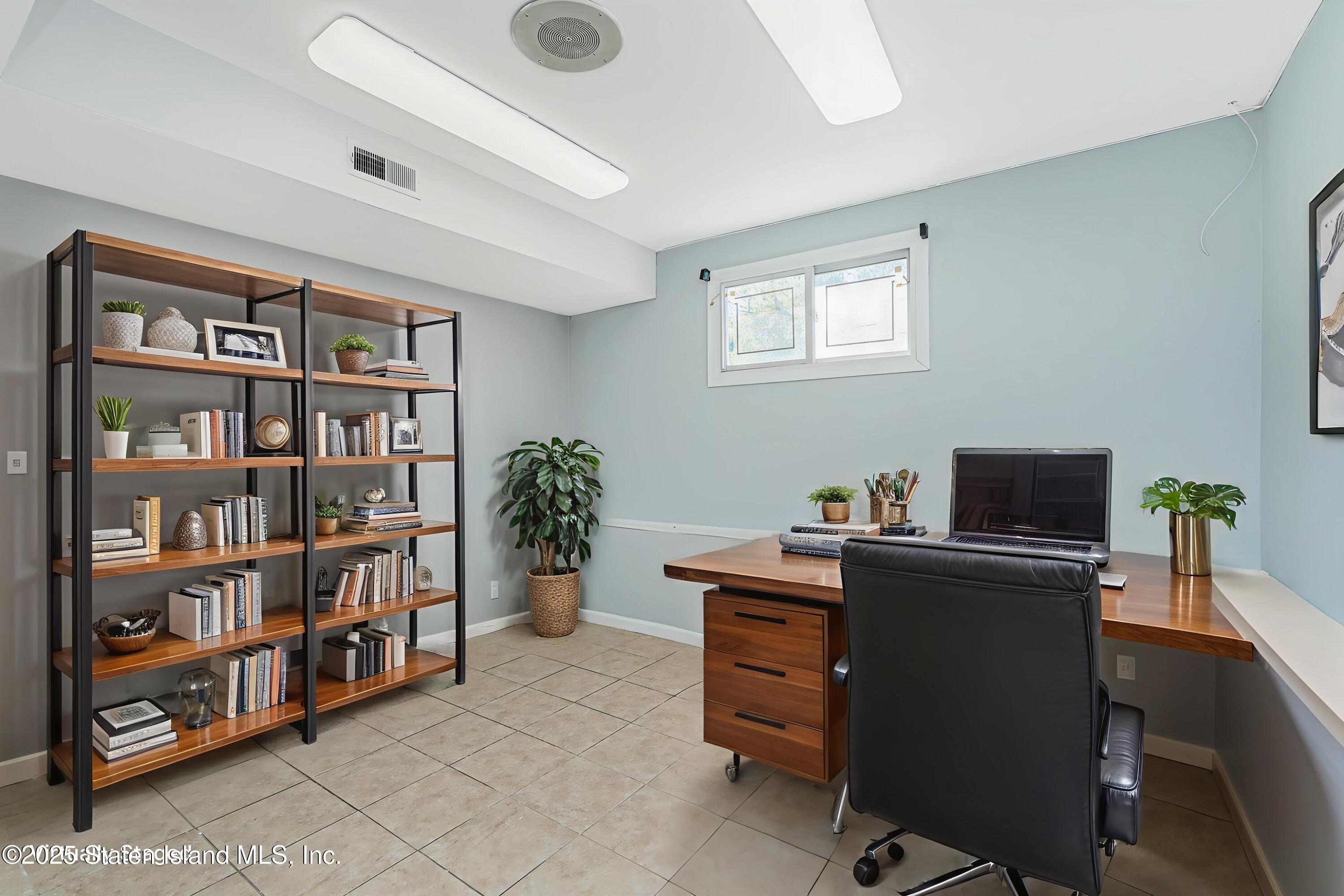 622 Barlow Avenue Staten Island, NY 10312 - Photo 15 of 27 a view of a workspace with a bookshelf