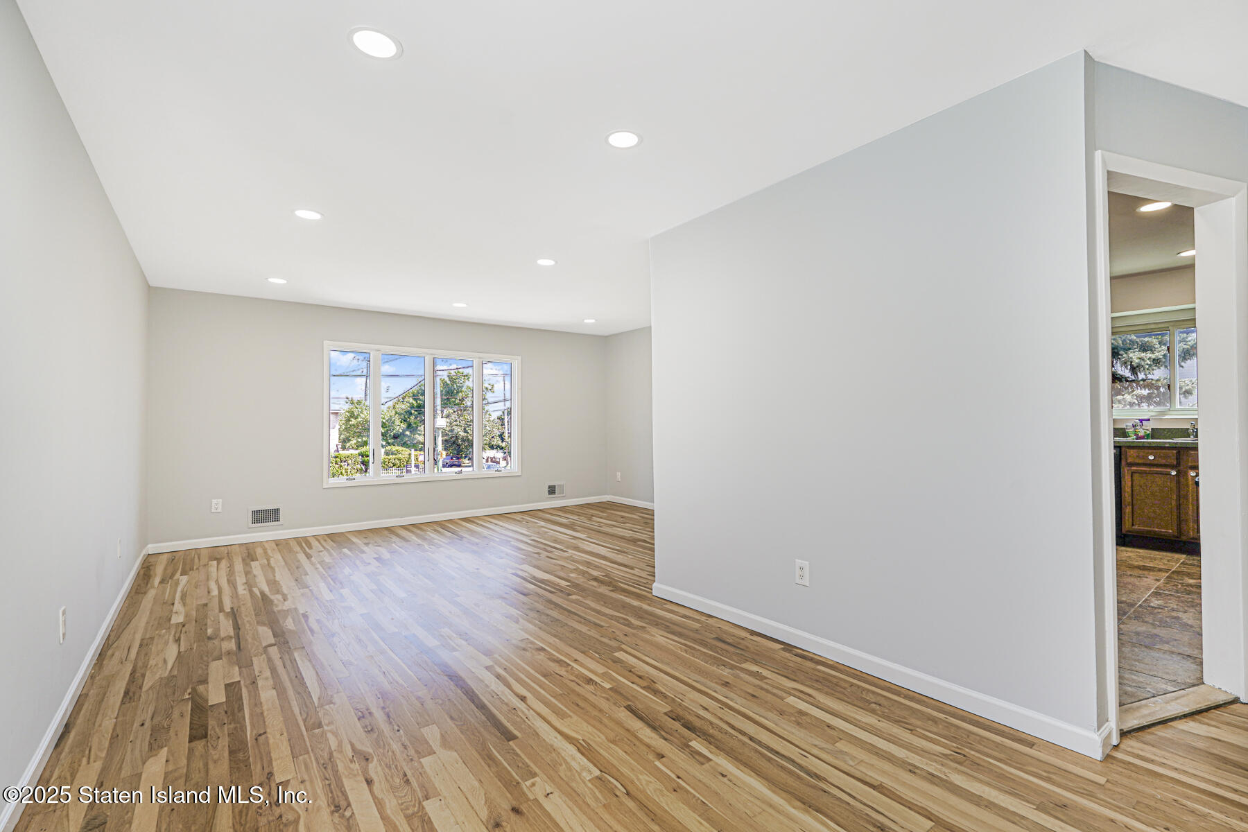 622 Barlow Avenue Staten Island, NY 10312 - Photo 9 of 27 wooden floor in an empty room with a window