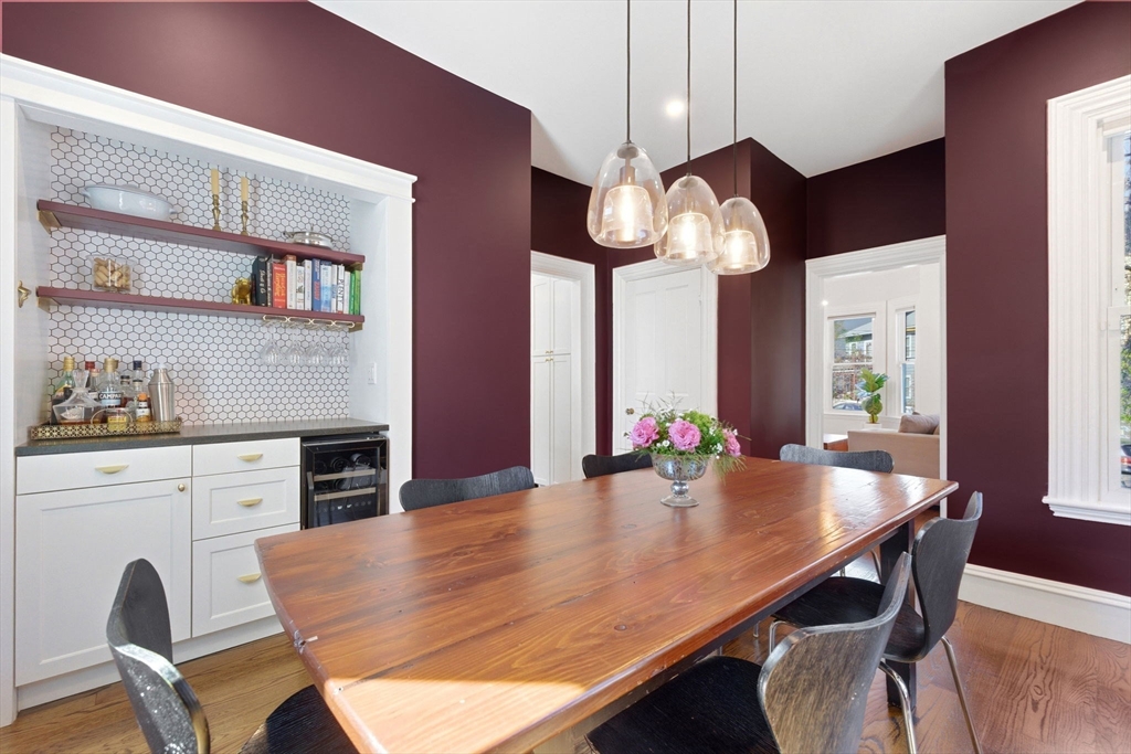 101 Forbes Street Boston, MA 02130 - Photo 12 of 38 a view of a dining room with furniture a chandelier and wooden floor