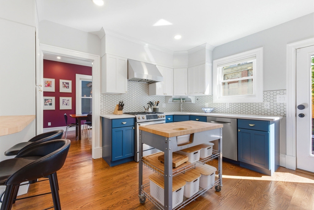 101 Forbes Street Boston, MA 02130 - Photo 15 of 38 a kitchen with granite countertop wooden cabinets and dining table