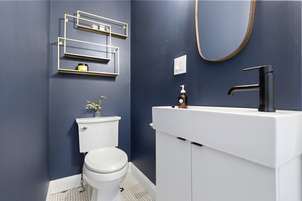 101 Forbes Street Boston, MA 02130 - Photo 18 of 38 a bathroom with a toilet a sink and mirror