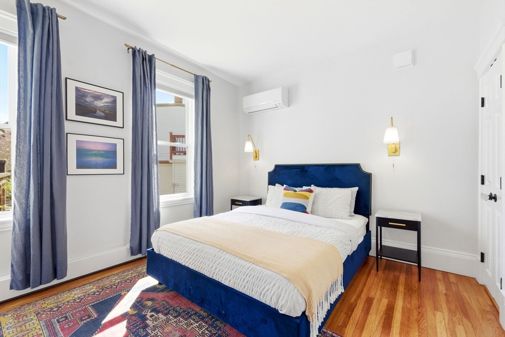 101 Forbes Street Boston, MA 02130 - Photo 21 of 38 a bedroom with a bed and a lamp on dresser
