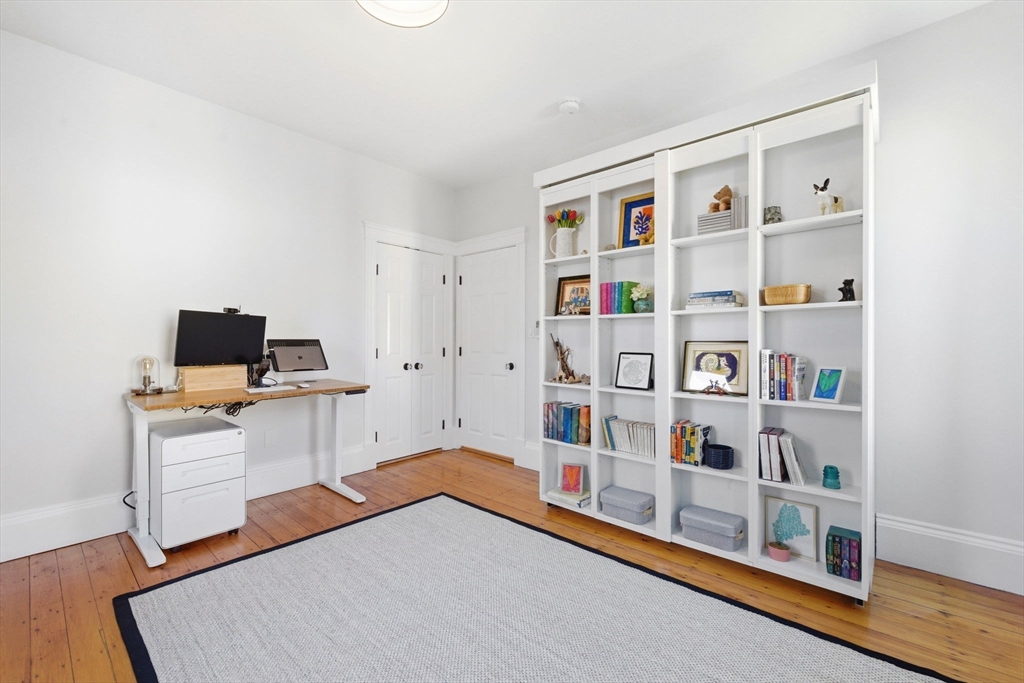 101 Forbes Street Boston, MA 02130 - Photo 26 of 38 a room with a bed and a book shelf