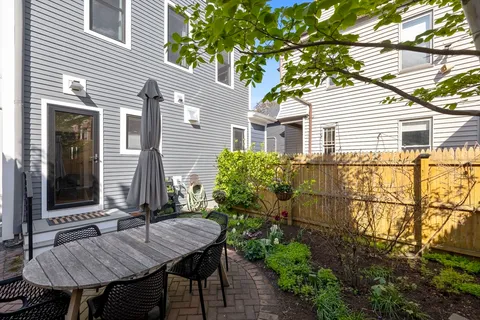 a view of a house with backyard and sitting area