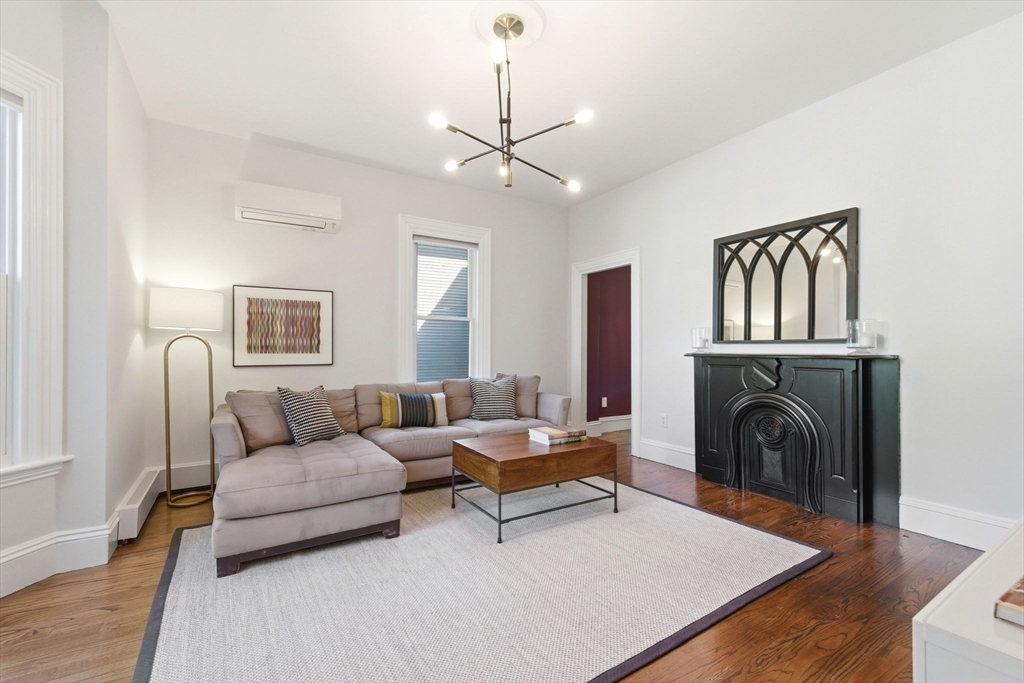 101 Forbes Street Boston, MA 02130 - Photo 7 of 38 a living room with furniture and a fireplace