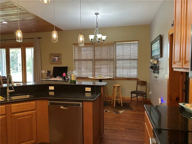 a kitchen with a counter space a sink a window and dining table