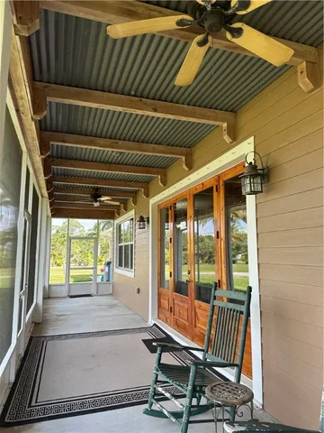 a view of a room with wooden floor and windows