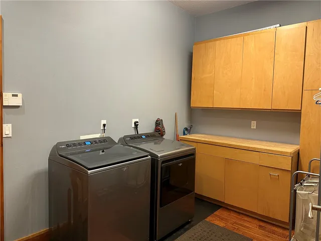 a utility room with sink dryer and washer