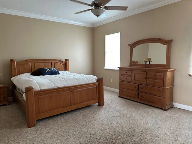 a bedroom with a bed and a dresser