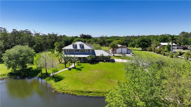 a view of a lake with a house in the background