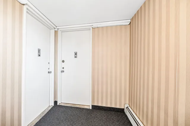 a view of a kitchen with wooden floor and electronic appliances
