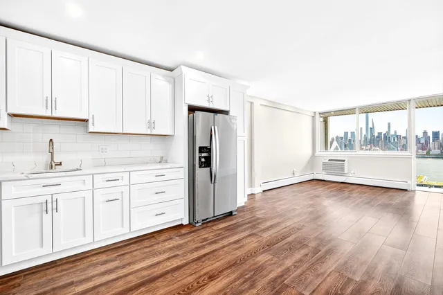 a kitchen with stainless steel appliances a refrigerator sink and microwave