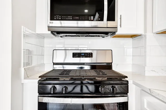 a view of a kitchen with wooden floor and electronic appliances
