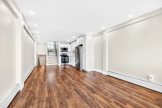 a view of a balcony with wooden benches