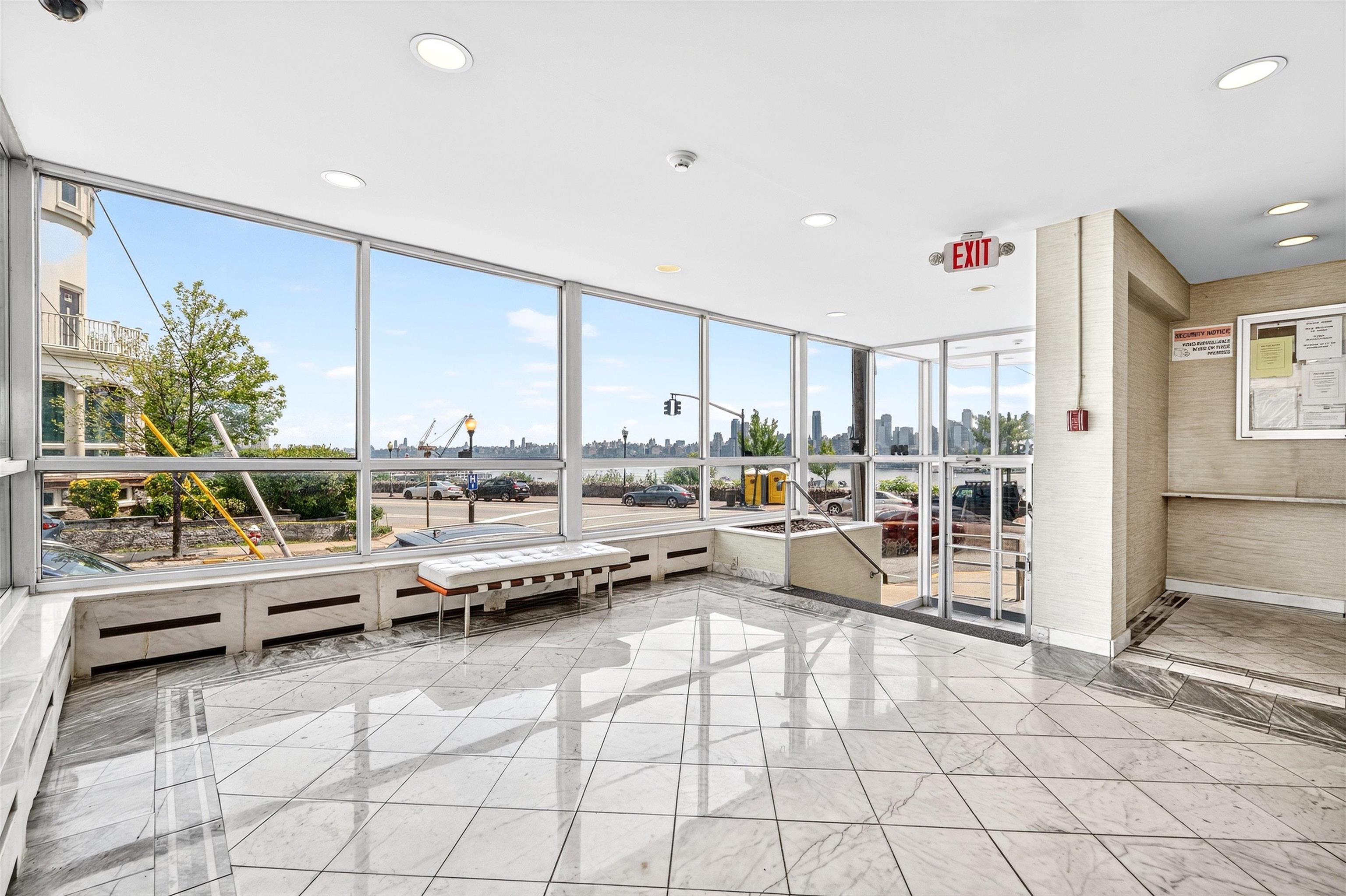 899 Boulevard East, Unit 4O Weehawken, NJ 07086 - Photo 9 of 50 a living room with furniture and a table