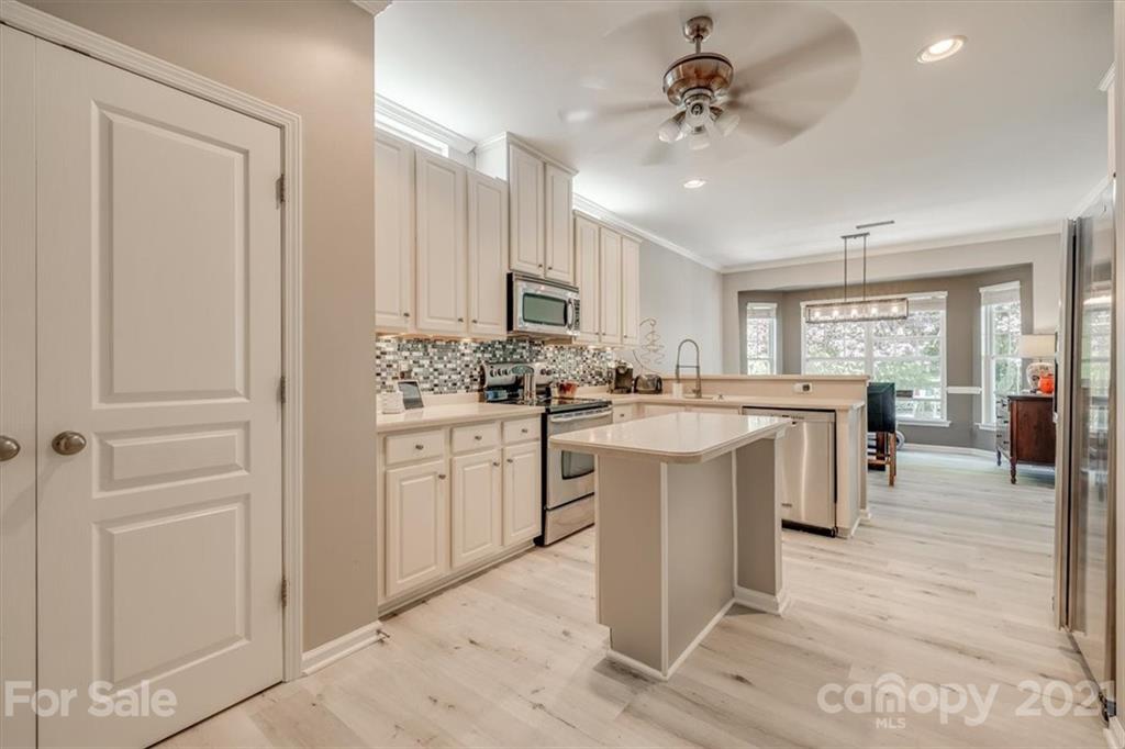 138 Whitley Mills Road Fort Mill, SC 29708 - Photo 14 of 38 a kitchen with kitchen island granite countertop a sink cabinets and stainless steel appliances