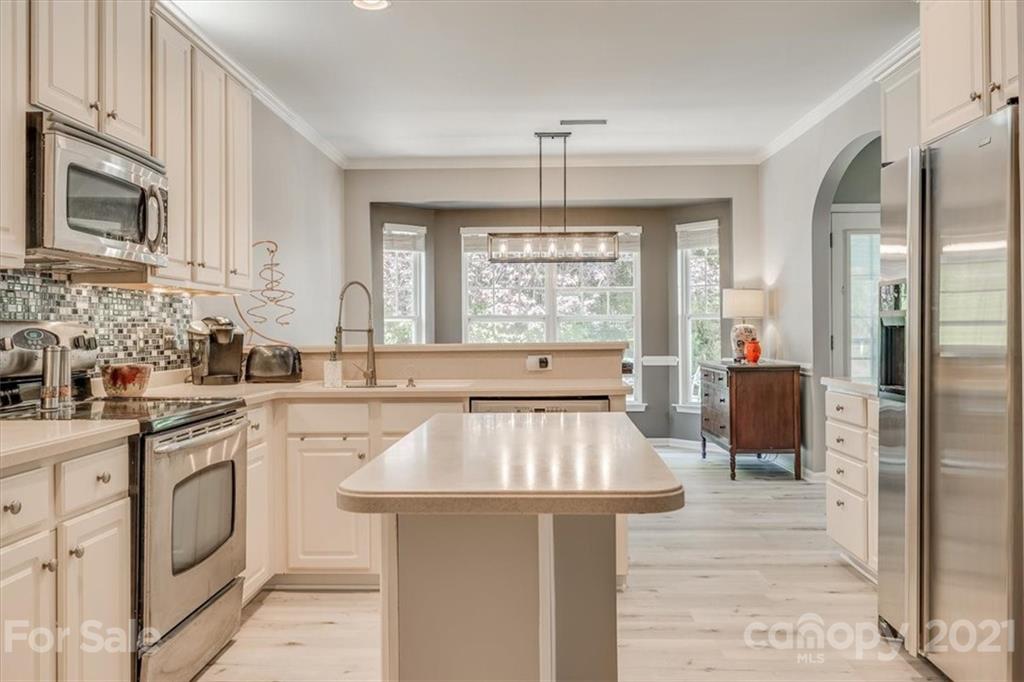 138 Whitley Mills Road Fort Mill, SC 29708 - Photo 17 of 38 a kitchen with stainless steel appliances granite countertop a sink stove and refrigerator