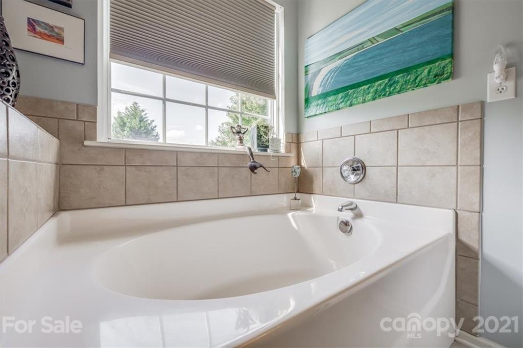 138 Whitley Mills Road Fort Mill, SC 29708 - Photo 21 of 38 a white bath tub sitting in a bathroom next to a window