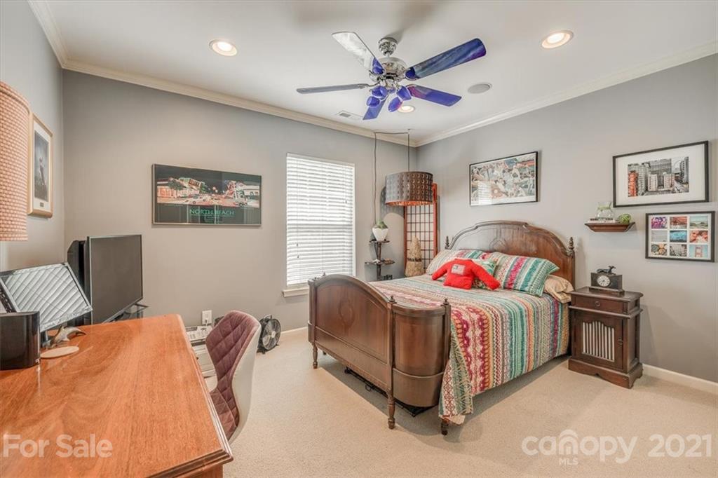 138 Whitley Mills Road Fort Mill, SC 29708 - Photo 28 of 38 a bedroom with a bed and a chandelier