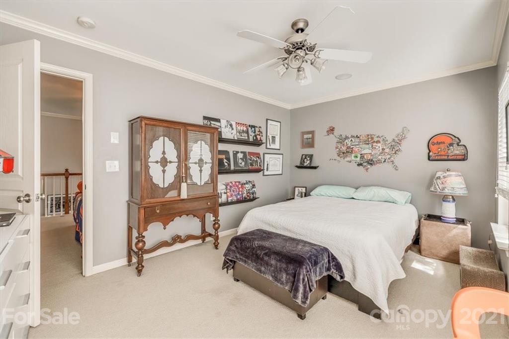 138 Whitley Mills Road Fort Mill, SC 29708 - Photo 33 of 38 a bedroom with a bed and a chandelier