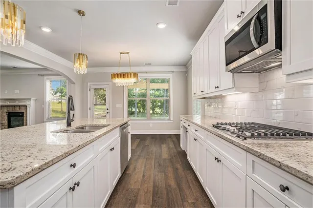 a view of empty room with window and chandelier