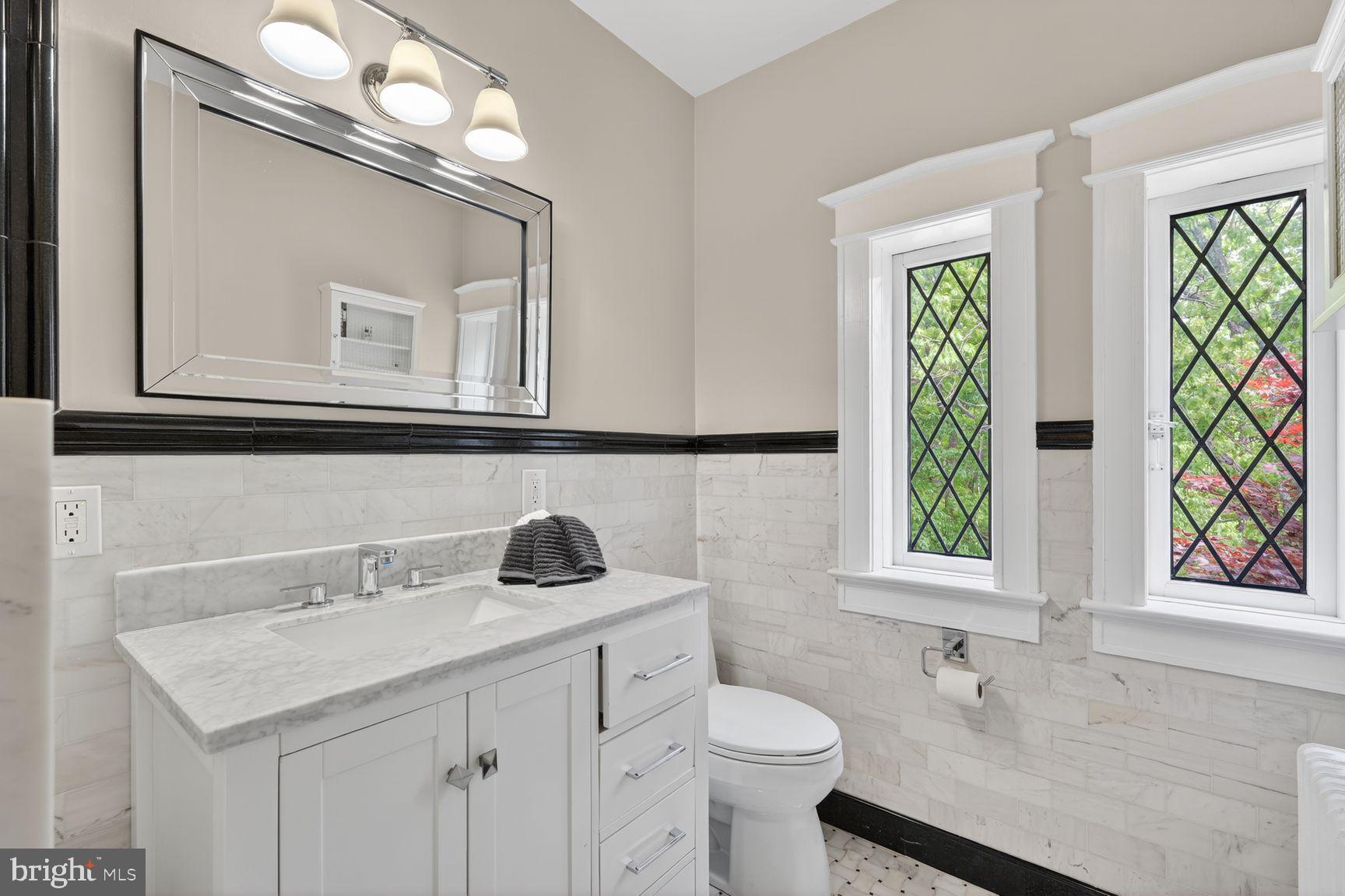 1616 44th Street Northwest Washington, DC 20007 - Photo 18 of 51 a bathroom with a sink a toilet and a mirror