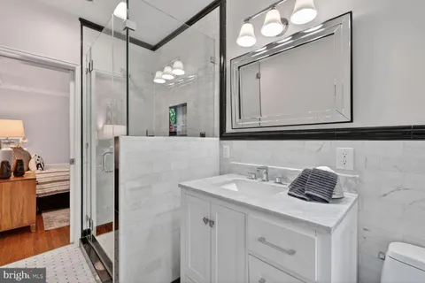 a bathroom with a sink vanity and a mirror