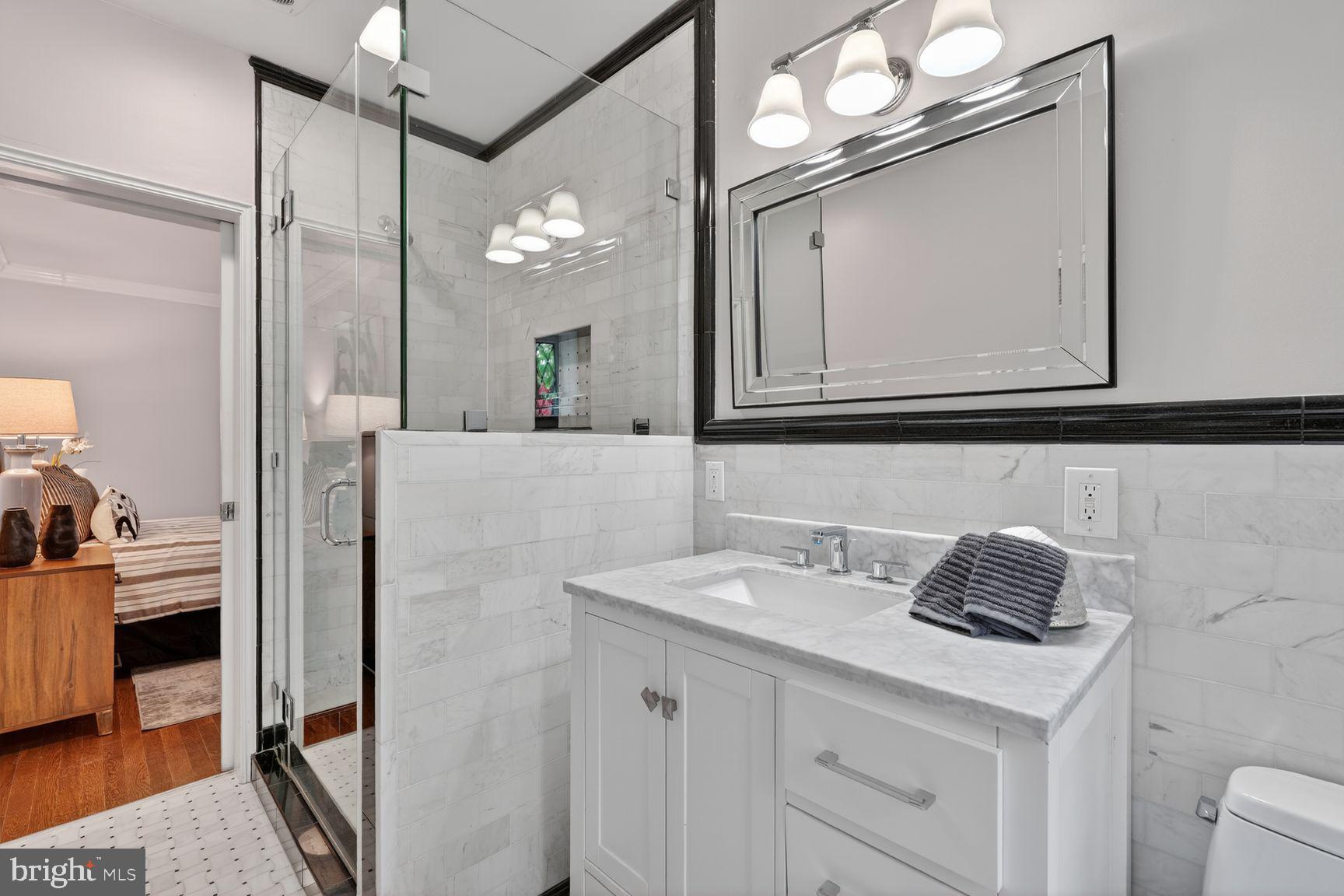 1616 44th Street Northwest Washington, DC 20007 - Photo 19 of 51 a bathroom with a sink vanity and a mirror