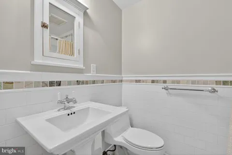 a bathroom with a sink mirror and toilet