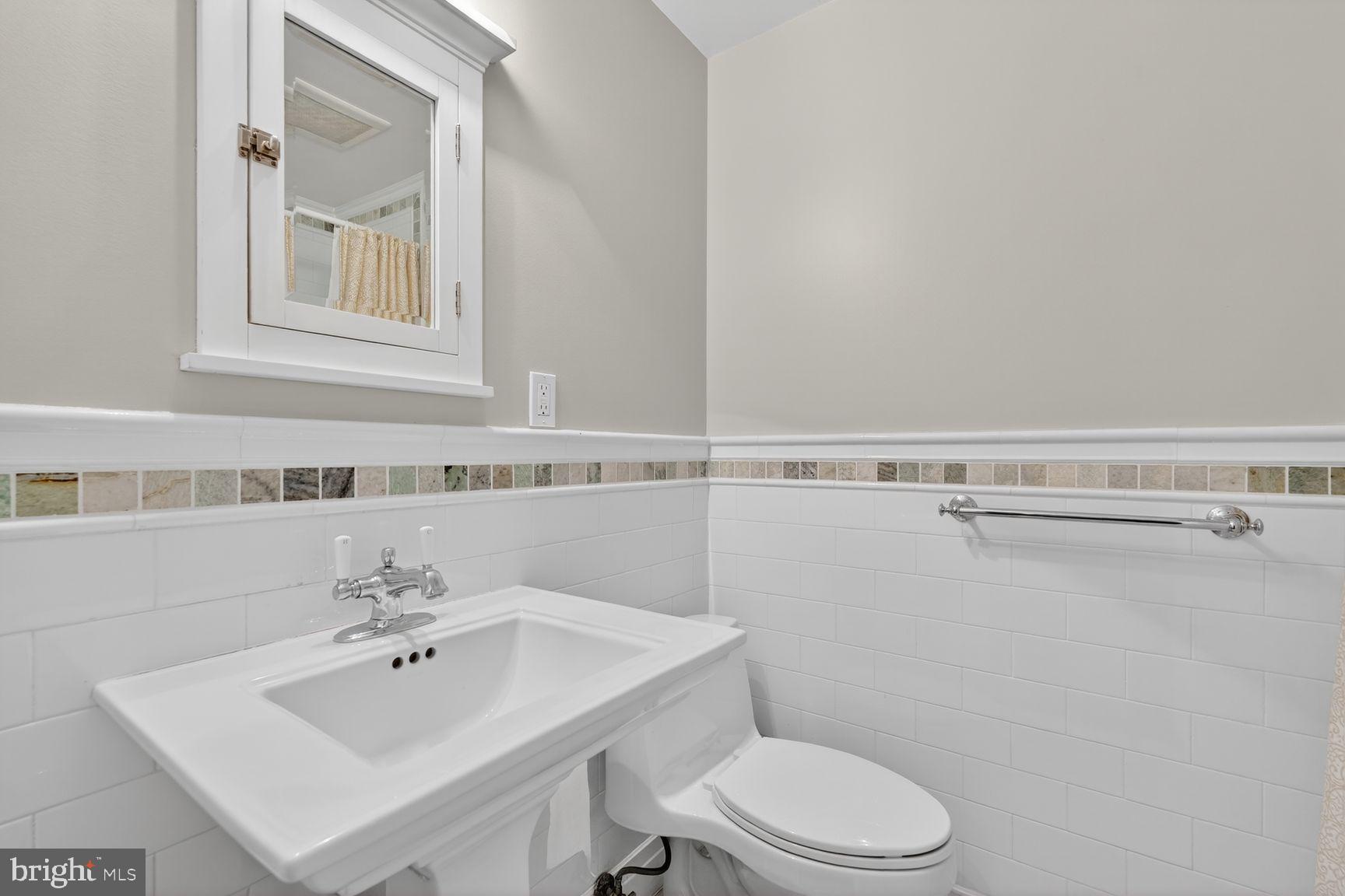 1616 44th Street Northwest Washington, DC 20007 - Photo 21 of 51 a bathroom with a sink mirror and toilet