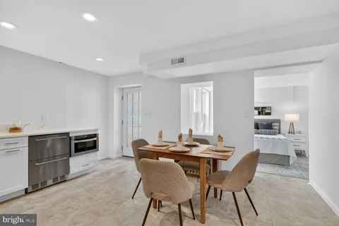 a view of a dining room with furniture and a kitchen