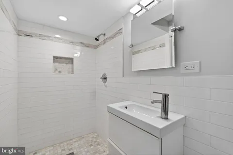 a bathroom with a sink a toilet and mirror