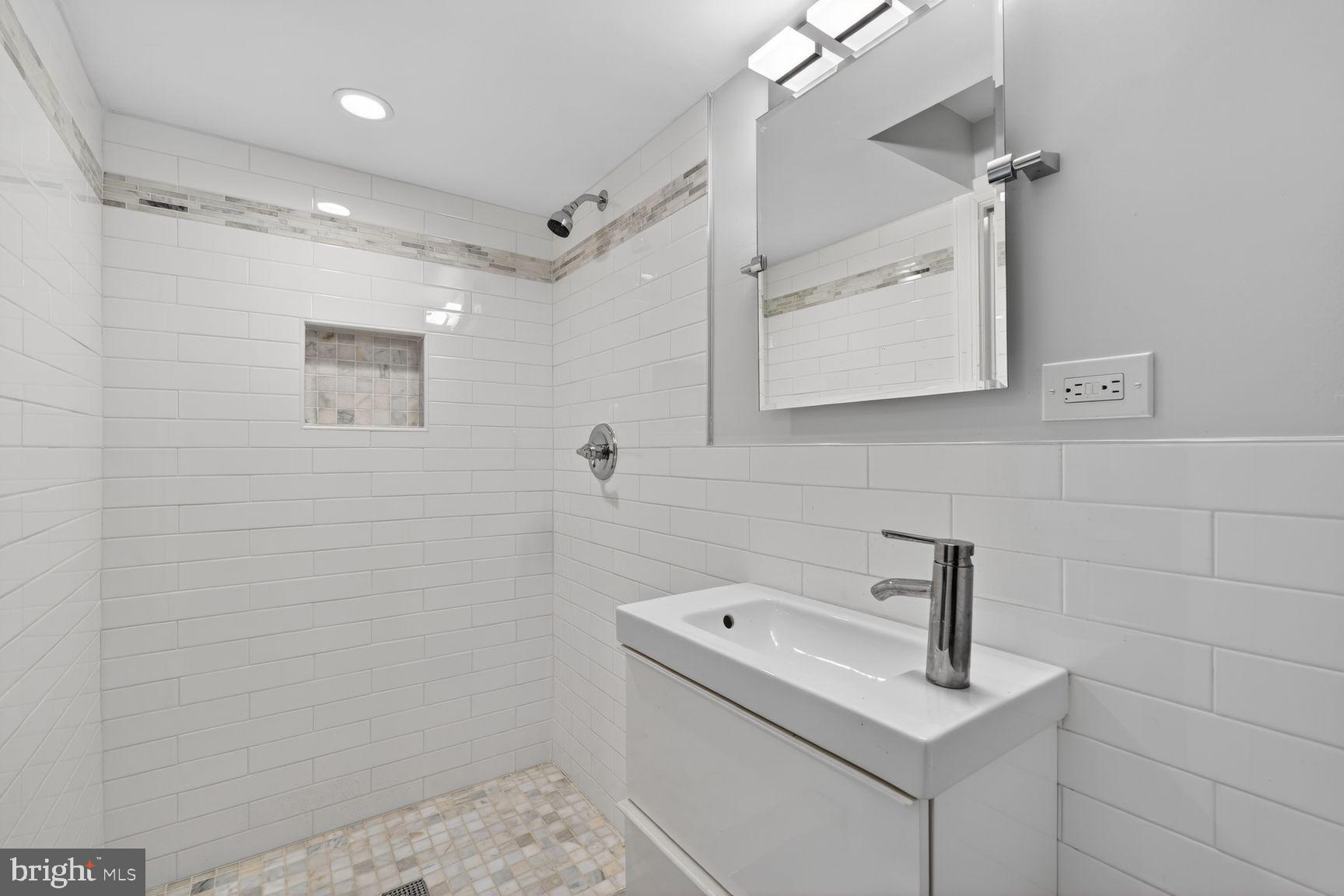 1616 44th Street Northwest Washington, DC 20007 - Photo 36 of 51 a bathroom with a sink a toilet and mirror