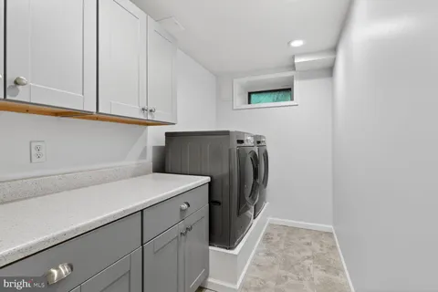 a kitchen with refrigerator and cabinets