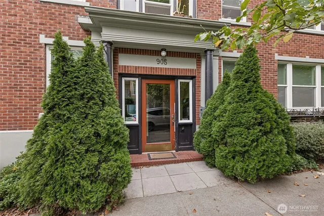 front view of a brick house with a large window