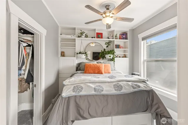 a bedroom with a bed and a large window