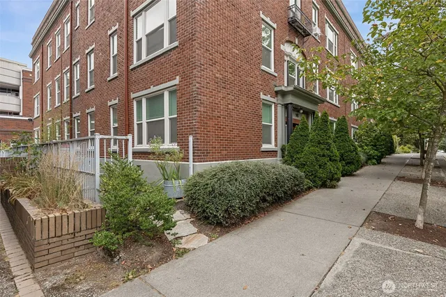 a view of a brick building next to a yard