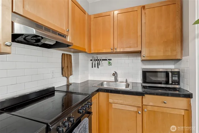 a kitchen with a sink and cabinets