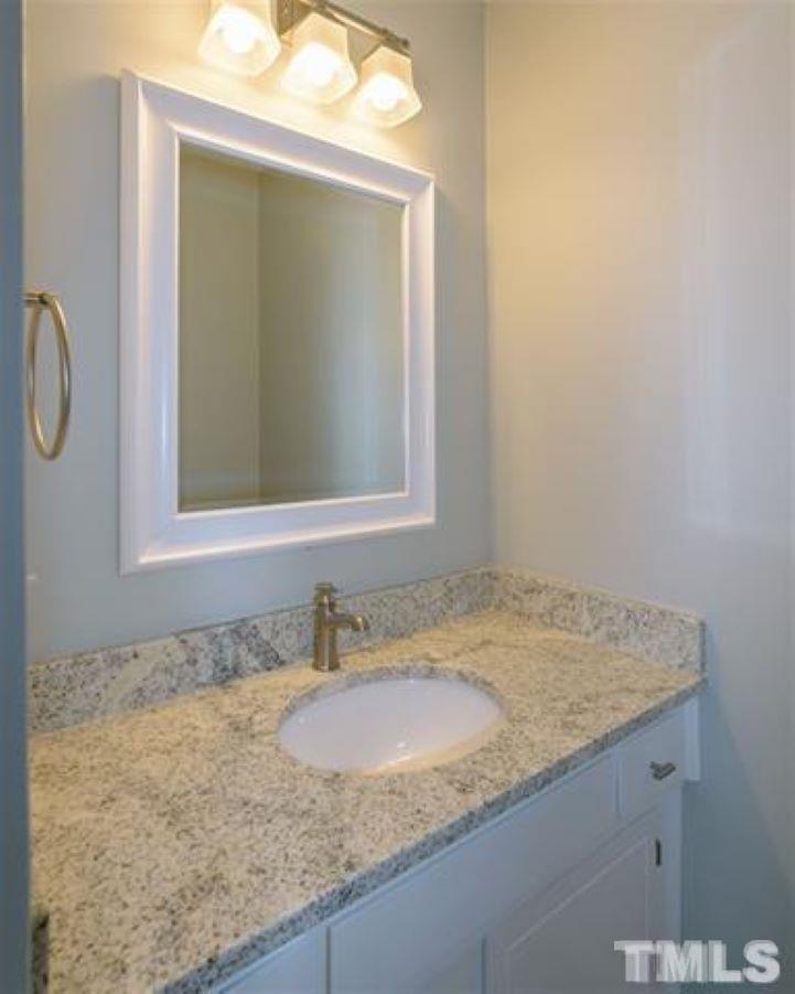 3148 Morningside Drive Raleigh, NC 27607 - Photo 16 of 24 a bathroom with a granite countertop sink and a mirror