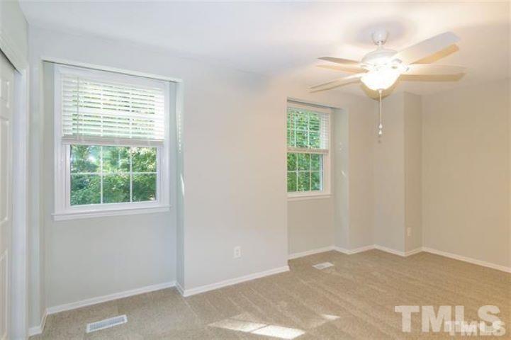 3148 Morningside Drive Raleigh, NC 27607 - Photo 18 of 24 a view of a livingroom with a chandelier fan and windows